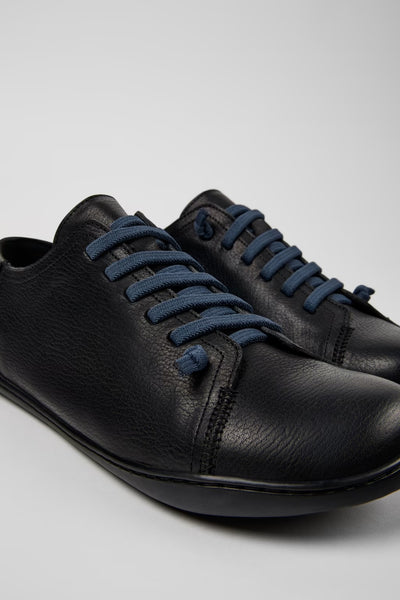 Angled close-up of Peu black leather men’s shoes showing stitching and texture on a white background.