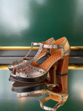 Chie Mihara KINTA heeled sandals in silver and green leather shown at an angle with perforated detailing and a brown heel