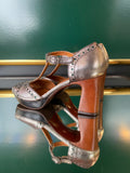 Chie Mihara KINTA heels shown from the rear angle with a brown block heel and silver leather upper