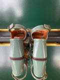 Chie Mihara OCHAN sandals viewed from the back with a glossy sage green finish, slingback strap and block heel