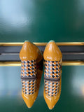 Chie Mihara MUFINI heels viewed from the back with a mustard yellow patent back panel and patterned block heel