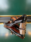 Chie Mihara VYKAR Black heels shown from the rear angle with a statement patterned heel in brown, black and white