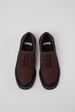 Top view of Pix burgundy and black leather men’s shoes showing silhouette on a white background.