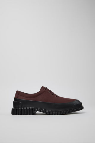 Profile view of burgundy and black leather men’s shoes showing textured EXTRALIGHT outsole on a white background.