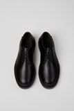 Top view of Dean black leather men’s shoes on a white background