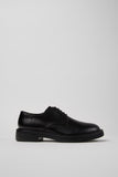 Dean black leather men’s shoes shown from the side on a white background