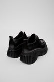 Back view of Camper Pix BCN black leather shoe highlighting heel detail on a white background