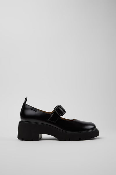 Black shoe with a strap on a light gray background