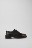 Side view of Dean brown and black calfskin leather shoes showing clean silhouette and lightweight EXTRALIGHT® outsole.