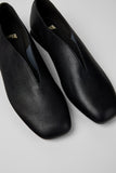 Angled close-up of Casi Myra black calfskin ballerinas showing leather texture and squared toe detail.