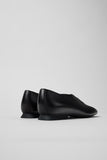 Rear view of Casi Myra black calfskin ballerinas showing heel shape and clean back seam.