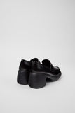 Back view of Camper Thelma II black leather moccasin showing heel shape and platform detail.