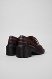 Back view of Camper Pix London burgundy leather moccasin showing heel and stitching detail on a white background