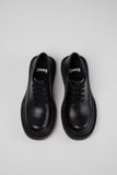 Top view of Camper Pix Berlin black leather shoe on a white background.