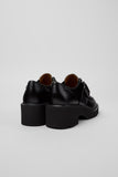 Back view of Camper Milah black calfskin leather shoes from Kron showing the chunky heel shape and smooth, structured design.