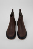Top view of brown nubuck ankle boots showing silhouette and rounded toe shape on a white background