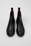 Pair of black Chelsea boots on a white background
