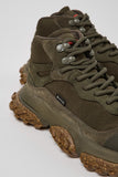Brown hiking boots with textured soles on a light gray background