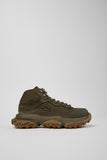 Brown hiking boot on a light gray background