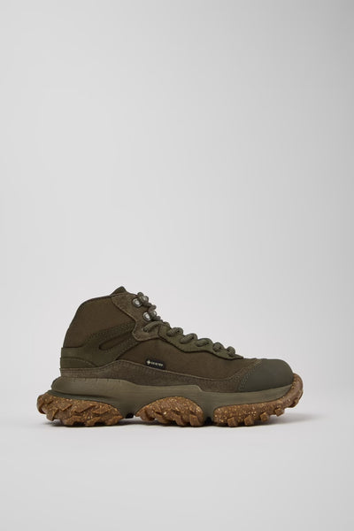 Brown hiking boot on a light gray background