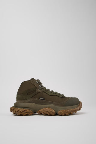 Brown hiking boot on a light gray background