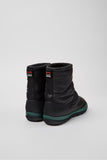 Rear view of Camper Peu Pista GM GORE-TEX boots showing black textile-leather upper and winter-ready MICHELIN® outsole.
