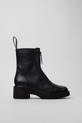 Black leather boot on a light gray background