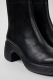 Close-up of Camper Thelma II black calfskin leather ankle boot showing texture, stitching, and platform construction.