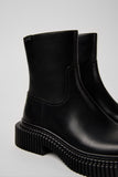 Close-up of Camper Pix Berlin black calfskin leather mid boot showing texture and construction details on a white background