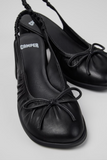 Kora black semi-open leather shoes for women with bow detail and low heel