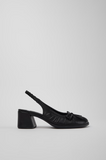 Side view of Kora black semi-open leather shoe with low heel