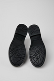 Outsole detail of Dean black leather shoes with patterned black sole