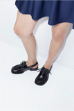 Donna black open-back leather shoes styled with a blue skirt