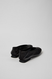Back view of Casi Myra black leather ballerinas with folded heel detail