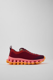 Side view of Camper x SUNNEI PELOTISSIMA sneaker with knitted upper and double-studded pink and orange outsole