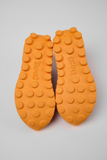 Outsole detail of Camper x SUNNEI PELOTISSIMA sneakers with orange double-studded grip sole