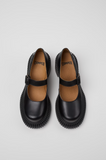 Top view of Camper Pix London black leather heeled moccasins with buckle straps.