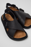 Black Lluc Sandal for men by Camper with crossed leather straps and adjustable buckles.