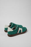 Rear angled view of green Pelotas Soller sneakers with cream heel detail and low-profile sole.