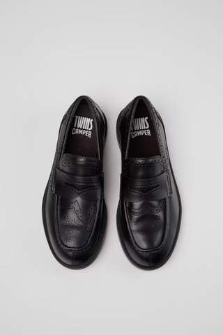 Top view of black Camper Twins leather moccasins with penny-loafer straps, brogue perforations and Camper Twins branding inside.