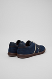Rear angled view of blue Camper Pelotas Soller sneakers showing the heel detail, textured upper and brown rubber outsole.