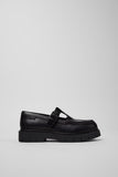 Side view of Camper Alaro black leather moccasins showing the low-profile upper and substantial rubber sole