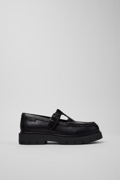 Side view of Camper Alaro black leather moccasins showing the low-profile upper and substantial rubber sole