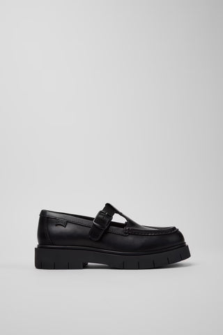 Side view of Camper Alaro black leather moccasins showing the low-profile upper and substantial rubber sole