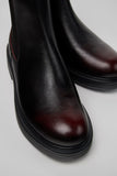 Close-up of Camper Dean black and burgundy leather ankle boots showing the leather panels and colour detailing