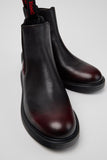 Close-up of Camper Dean men's leather ankle boots showing the black and burgundy colour combination and leather detailing