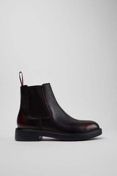Side view of Camper Dean men's black and burgundy leather ankle boots showing the Chelsea-style silhouette and low heel