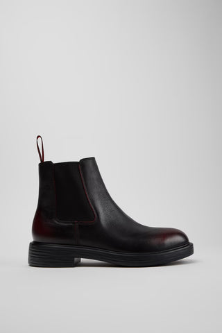 Side view of Camper Dean men's black and burgundy leather ankle boots showing the Chelsea-style silhouette and low heel