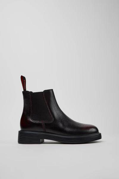 Side view of Camper Dean black and burgundy leather ankle boots showing the ankle-height silhouette