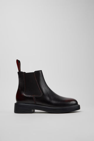 Side view of Camper Dean black and burgundy leather ankle boots showing the ankle-height silhouette